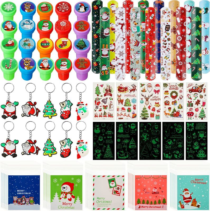 Photo 1 of 260 Pieces Christmas Stocking Stuffers Include 110 Temporary 100 Christmas Candy Bags 20 Christmas Stampers 15 Slap Bracelets 15 Keychains for Christmas Party Favors Game Reward Decor