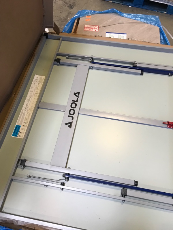 Photo 1 of JOOLA Nova DX Outdoor/Indoor All-Weather Table Tennis Table with Ping Pong Net Set, 6mm Surface, Regulation Size 9' x 5', Blue-------TABLE HAS A FEW SCRATCHES ON THE BACK