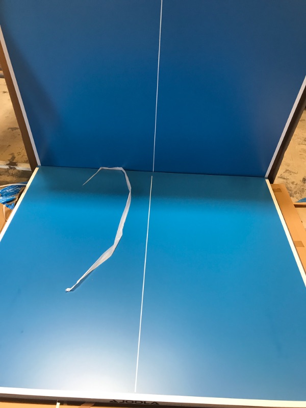 Photo 1 of JOOLA Nova DX Outdoor/Indoor All-Weather Table Tennis Table with Ping Pong Net Set, 6mm Surface, Regulation Size 9' x 5', Blue-------TABLE HAS A FEW SCRATCHES ON THE BACK