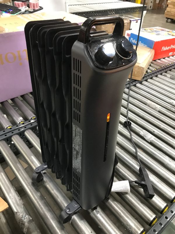 Photo 1 of Amazon Basics Portable Radiator Heater with 7 Wavy Fins, Manual Control, Black, 1500W