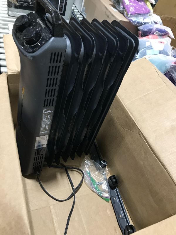 Photo 1 of Amazon Basics Portable Radiator Heater with 7 Wavy Fins, Manual Control, Black, 1500W