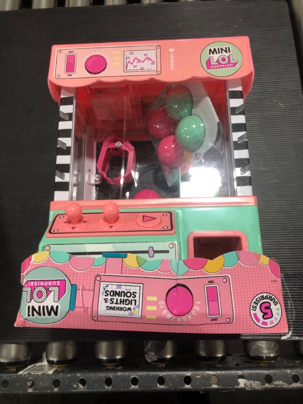 Photo 2 of L.O.L. Surprise! Minis Claw Machine Playset with 5 Surprises with Lights & Exclusive LOL Mini Family, Holiday Toy Great Gift for Kids Girls Boys Ages 4 5 6+ Years Old & Collectors