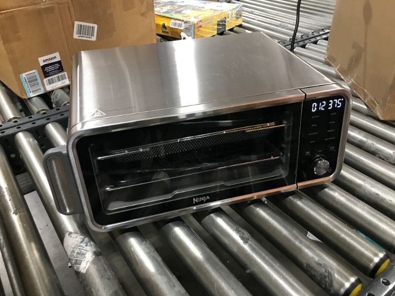 Photo 2 of Ninja SP101 Digital Air Fry Countertop Oven with 8-in-1 Functionality, Flip Up & Away Capability for Storage Space, with Air Fry Basket, Wire Rack & Crumb Tray, Silver
