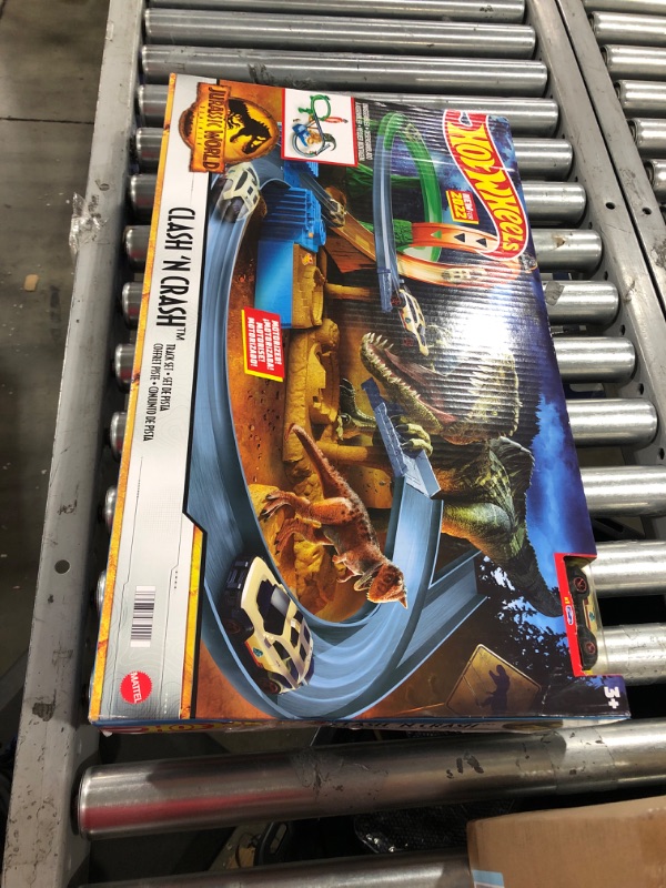 Photo 1 of Hot Wheels Jurassic World Dominion Clash ‘N Crash Track Set with 1 Hot Wheels Car, Motorized Booster with Attacking Dinosaurs, Toy Gift Set for Dino Fans