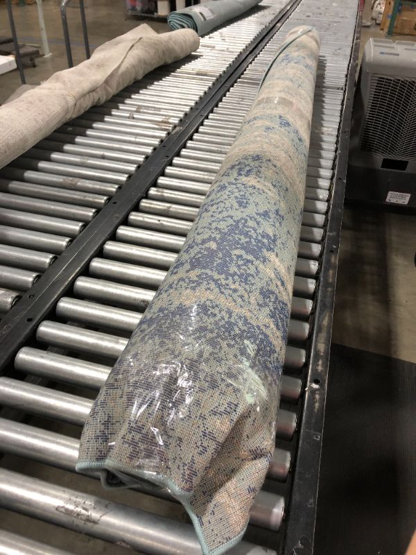 Photo 1 of blue and white rug 109" long, unknown width.
