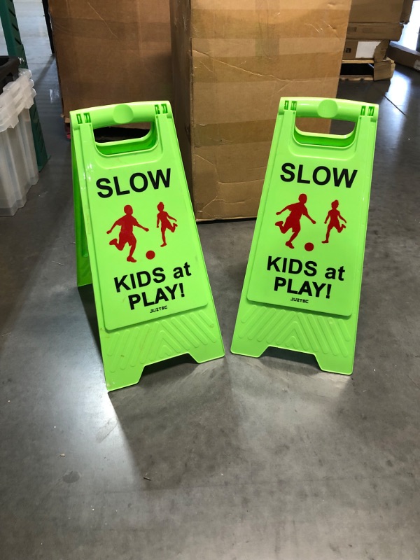 Photo 2 of Slow Kids at Play Sign, with Double-Sided Text and Graphics for Street Neighborhoods (2-Pack Green)