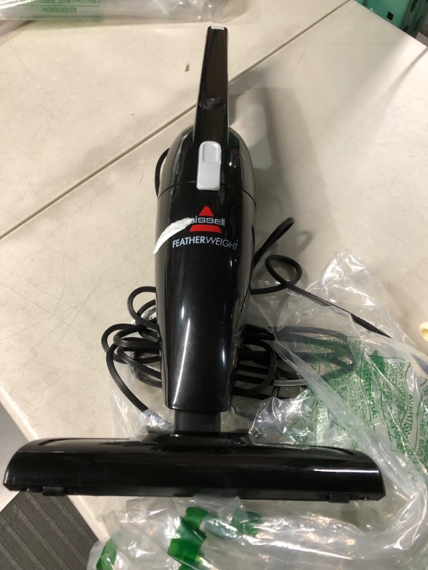 Photo 2 of **USED** HANDLE BAR MISSING** BISSELL FeatherWeightâ Featherweight Stick Lightweight Bagless Vacuum with Crevice Tool, 2033M, Black