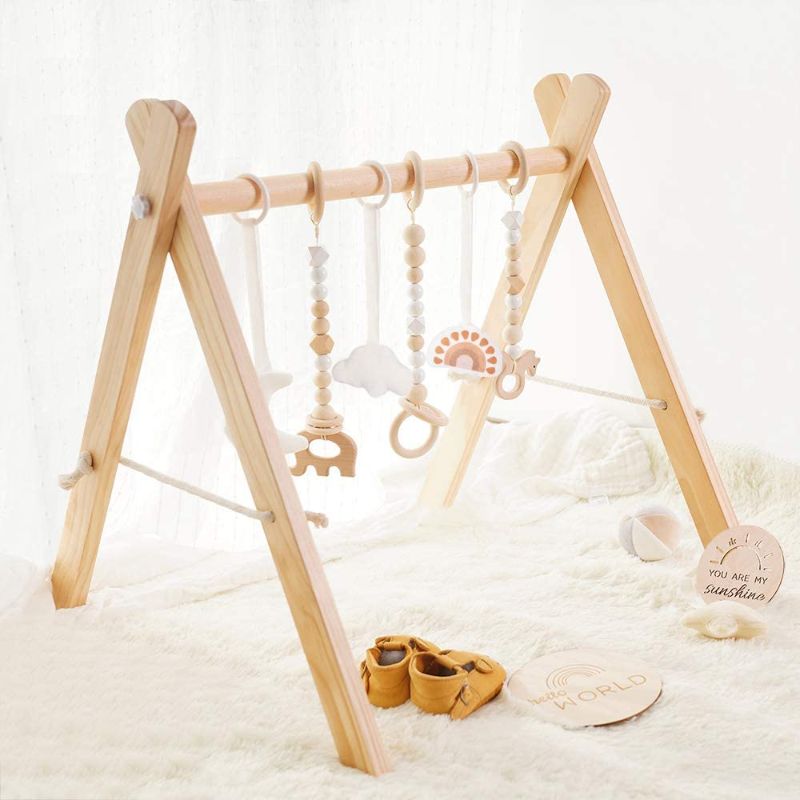 Photo 1 of Baby Play Gym Wooden Baby Gym with 6 Toys Foldable Play Gym Frame Activity Gym Hanging Bar Baby Toy White
