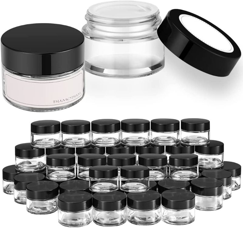 Photo 1 of 1 oz Round Clear Glass Jars, Bumobum 48 pack Cream Jars with Black Lids, White Labels & Inner Liners, Empty Cosmetic Containers for Cream, Lotion