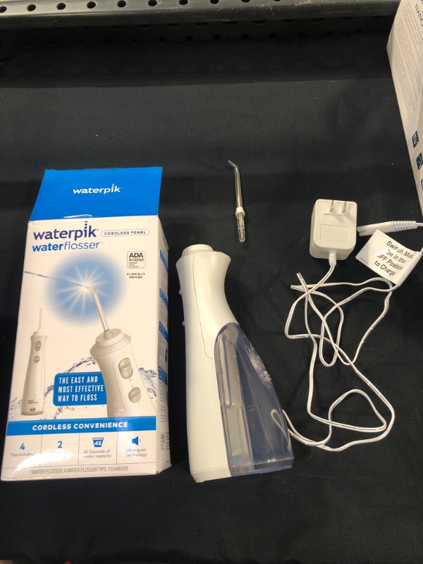 Photo 2 of Waterpik Cordless Plus Water Flosser with 4 Flossing Tips, Rechargeable and Portable for Travel and Home, White WP-450 (USED ITEM ) 
