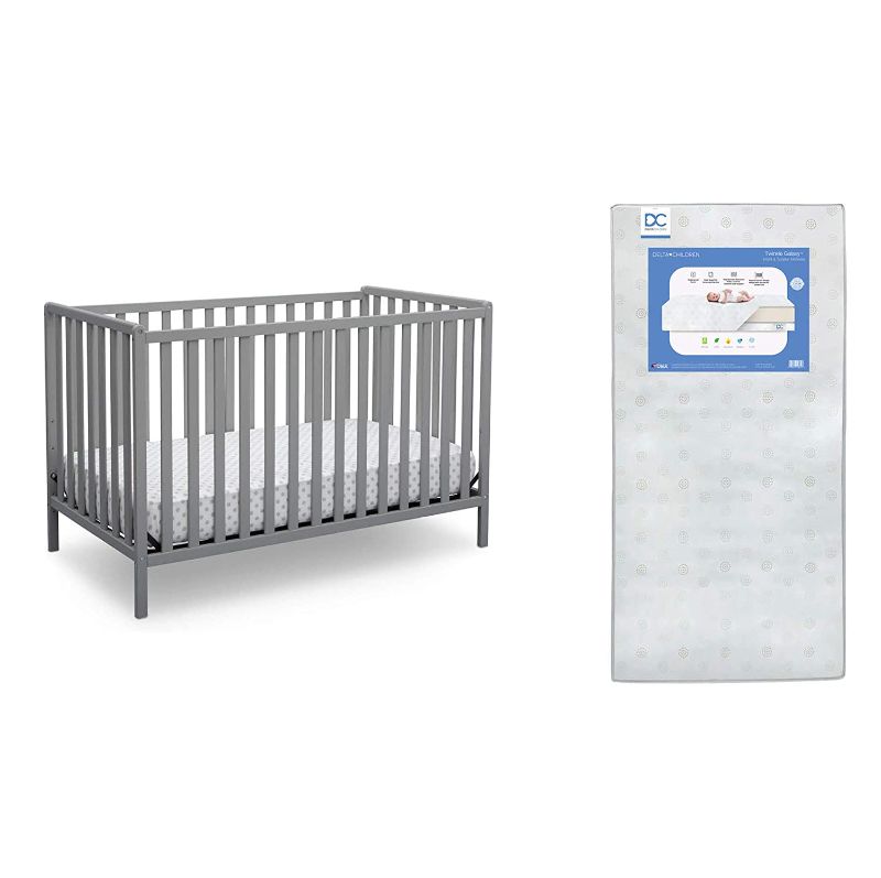 Photo 1 of Delta Children Heartland 4-in-1 Convertible Crib, Grey + Delta Children Twinkle Galaxy Dual Sided Recycled Fiber Core Crib and Toddler Mattress (Bundle), box damage
