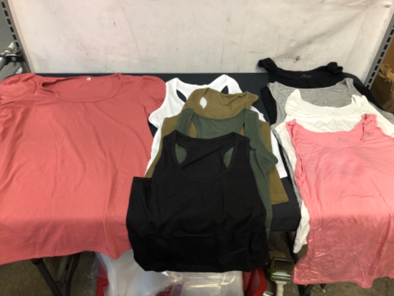 Photo 1 of BAG OF WOMENS CLOTHING ITEMS- PINK SHIRT SIZE M,  4 PACK OF CROP TOPS SIZE L, 4 PACK OF TANKS SIZE M ---- SOLD AS IS ----  