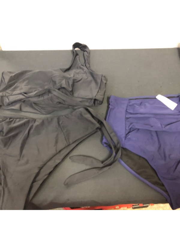 Photo 1 of BAG LOT OF WOMENS- SWIMWEAR BLACK TWO PIECE SIZE XL 
NAVY BLUE BOTTOMS SIZE M 
---- SOLD AS IS ----