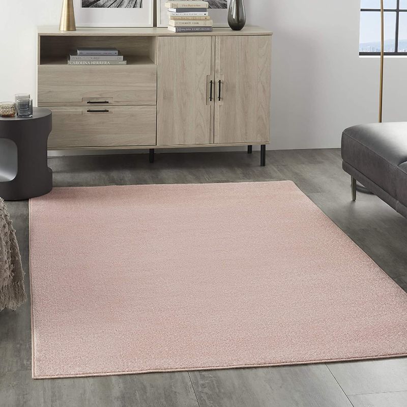 Photo 1 of  Nourison Essentials Solid Contemporary Pink 4' X 6' Area Rug, Creases and Wrinkles in Rug, Hair Found on Rug, Moderate Use, Fraying on Edges.
