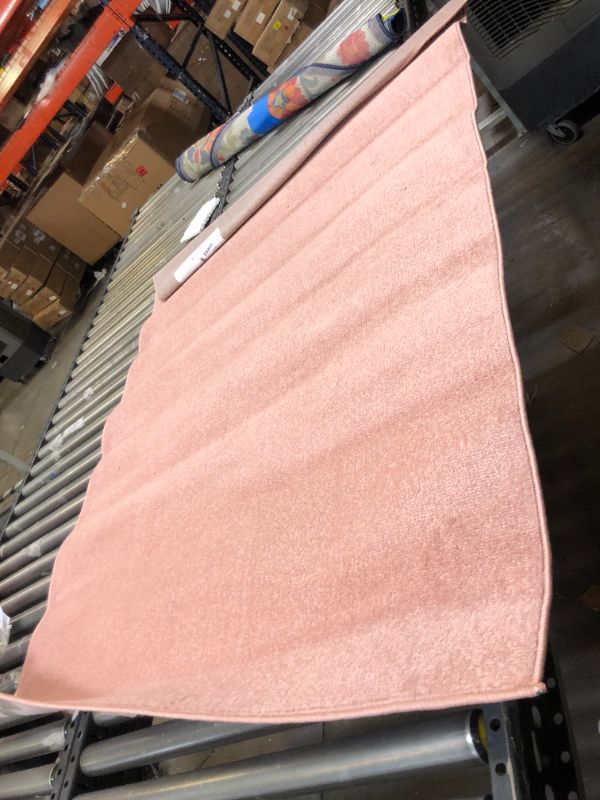 Photo 1 of  Nourison Essentials Solid Contemporary Pink 4' X 6' Area Rug, Creases and Wrinkles in Rug, Hair Found on Rug, Moderate Use, Fraying on Edges.
