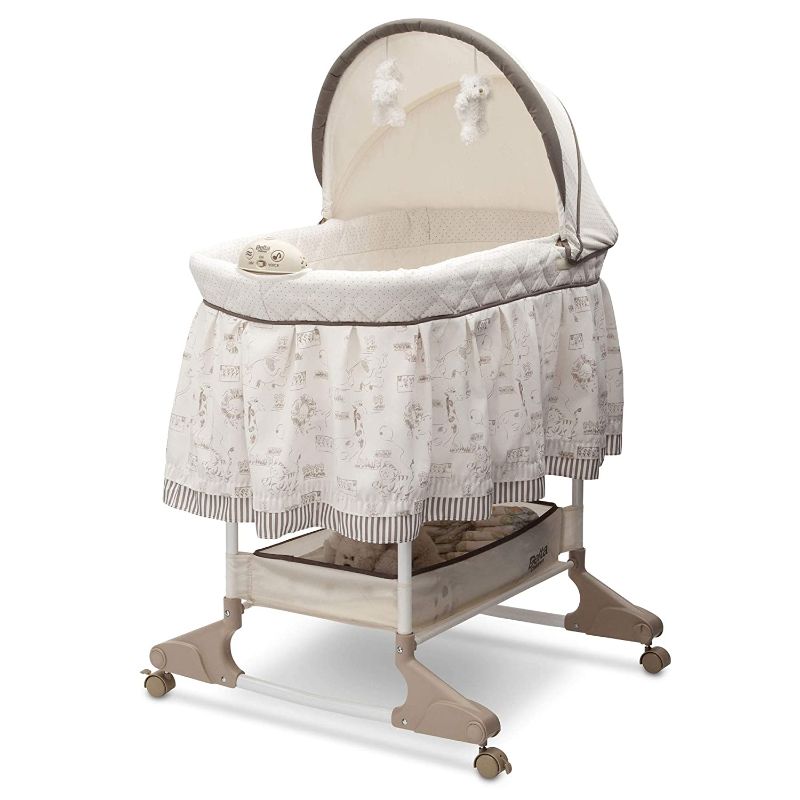 Photo 1 of Delta Children Rocking Bedside Bassinet - Portable Crib with Lights Sounds and Vibrations, Play Time Jungle.  Box Packaging Damaged, Minor Use, Found Hair on Item. 
