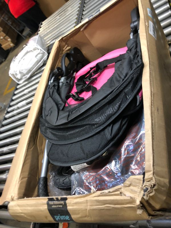 Photo 3 of Baby Trend Expedition Jogger Stroller, Bubble Gum. Box Packaging Damaged, Heavy Use, Scratches and Scuffs on Plastic, Found Rip in Fabric, Found Hair on item, Wear on wheels. Missing small hardware for Wheels.
