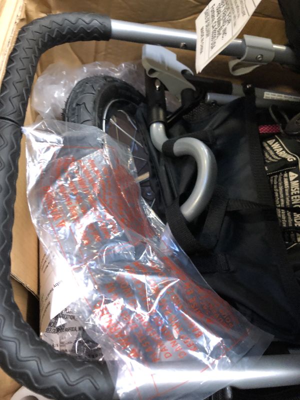 Photo 1 of Baby Trend Expedition Jogger Stroller, Bubble Gum. Box Packaging Damaged, Heavy Use, Scratches and Scuffs on Plastic, Found Rip in Fabric, Found Hair on item, Wear on wheels. Missing small hardware for Wheels.
