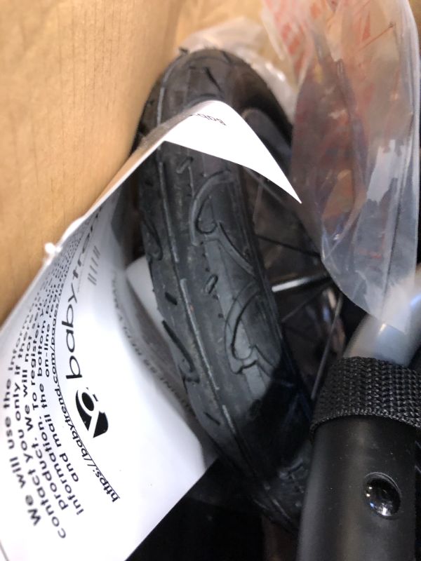 Photo 8 of Baby Trend Expedition Jogger Stroller, Bubble Gum. Box Packaging Damaged, Heavy Use, Scratches and Scuffs on Plastic, Found Rip in Fabric, Found Hair on item, Wear on wheels. Missing small hardware for Wheels.
