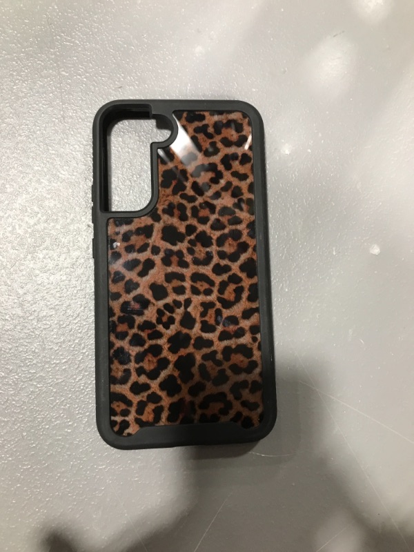 Photo 1 of cheetah print phone case, phone type unknown.