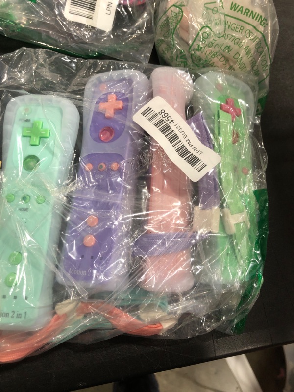 Photo 1 of wii u controllers green purple and pink comes with the cases 