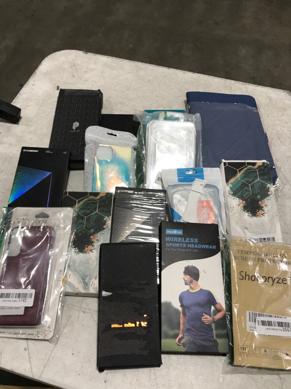 Photo 1 of Small box lot of phone cases and tablet case. New and used, various styles, sold as is.