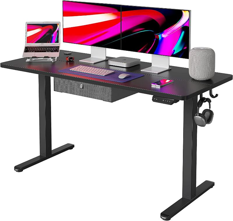 Photo 1 of FEZIBO 55 x 24 Inches Standing Desk with Drawer, Adjustable Height Electric Stand up Desk, Sit Stand Home Office Desk, Ergonomic Workstation Black Steel Frame/Black Tabletop
