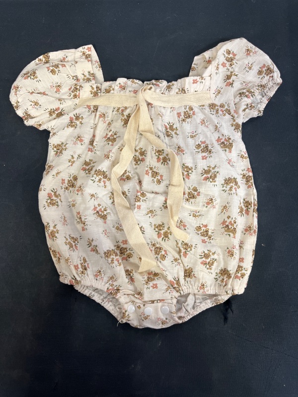 Photo 1 of BABY GIRL FLORAL ONESIE, SIZE READS 3T, ITEM LOOKS LIKE A SIZE 12MOS