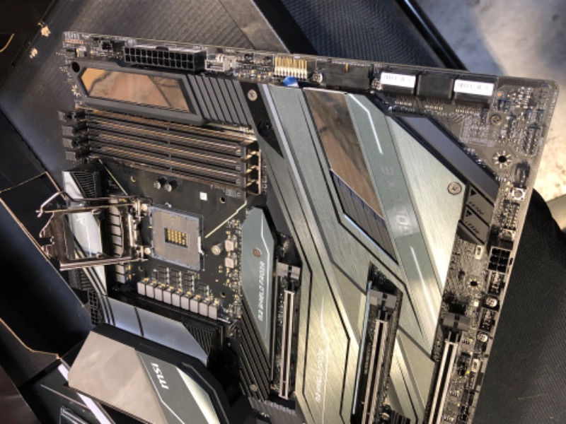 Photo 1 of MSI MEG Z490 GODLIKE Gaming Motherboard (E-ATX, 10th Gen Intel Core, LGA 1200 Socket, DDR4, SLI/CF, Triple M.2 Slots, Thunderbolt 3 Type-C, Wi-Fi 6, Mystic Light RGB) DAMAGED PIN BOTTOM RIGHT/ DAMAGED / DAMAGED / DAMAGED / DAMAGED / USED FOR PARTS ONLY 

