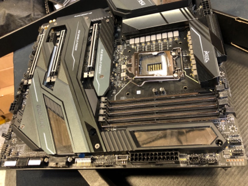 Photo 2 of MSI MEG Z490 GODLIKE Gaming Motherboard (E-ATX, 10th Gen Intel Core, LGA 1200 Socket, DDR4, SLI/CF, Triple M.2 Slots, Thunderbolt 3 Type-C, Wi-Fi 6, Mystic Light RGB) DAMAGED PIN BOTTOM RIGHT/ DAMAGED / DAMAGED / DAMAGED / DAMAGED / USED FOR PARTS ONLY 

