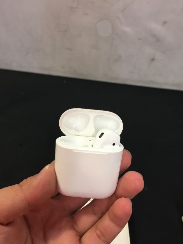 Photo 2 of Apple AirPods  Wireless Earbuds with Lightning Charging Case Included. Over 24 Hours of Battery Life, Effortless Setup. Bluetooth Headphones for iPhone
