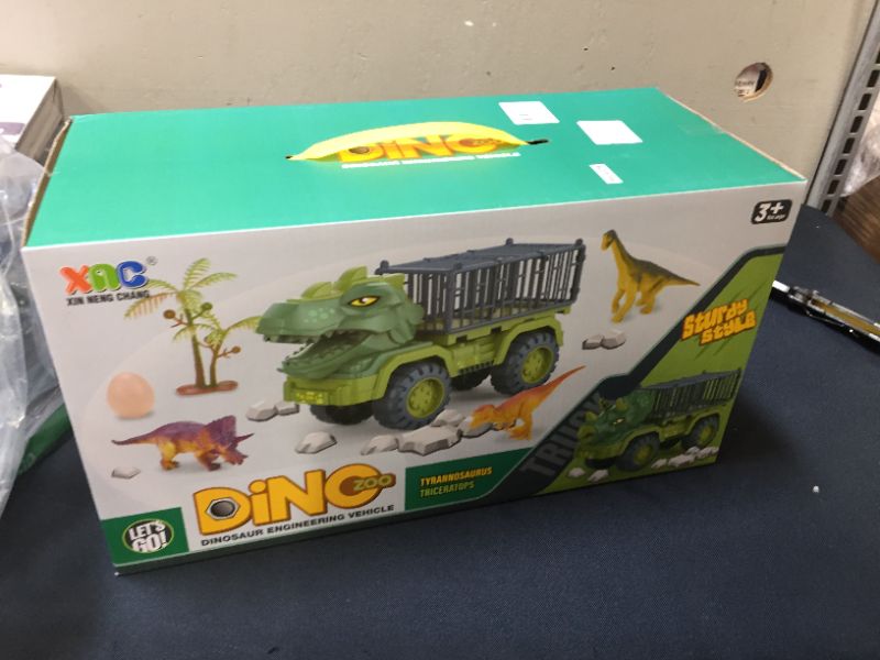 Photo 2 of Dinosaur Transport Truck Car with Dinosaur Toys for Kids 3-5 Boys Girls Birthday Gift Truck Toys Car with 15 Dino Figures Egg and Tree
