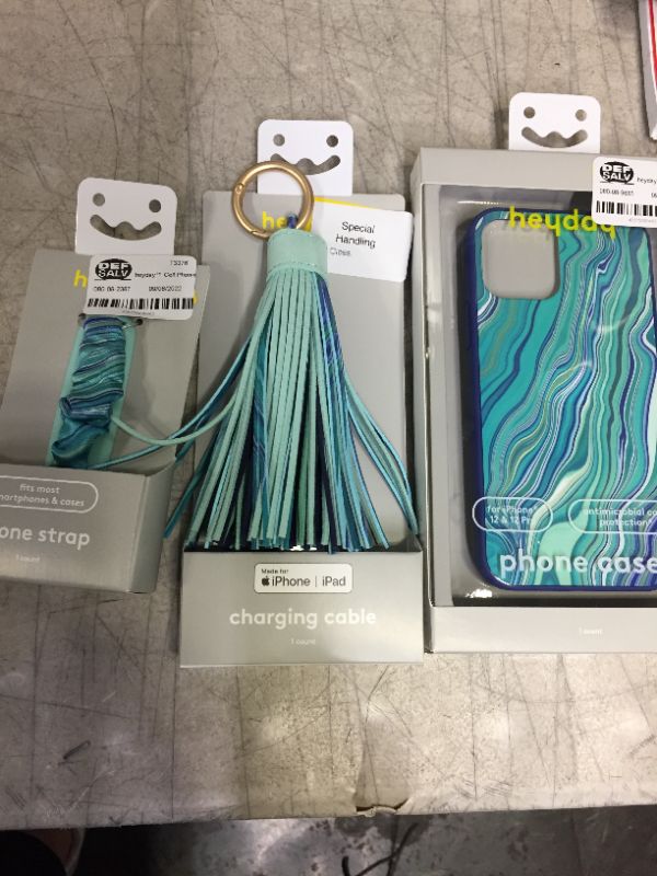 Photo 1 of PHONE CASE, CHARGING CABLE AND PHONE STRAP BUNDLE --SOLD AS IS ---