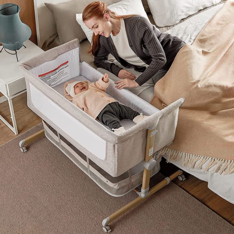 Photo 1 of Baby Bassinet Bedside Sleeper, besrey Bedside Bassinet for Newborn Infant with Comfy Mattress, 9 Height Positions, Adjustable Bedside Crib with 360° Swivel Wheels, Bassinet Sleeper with Storage Basket 39.4"L x 26.6"W x 36.4"H

