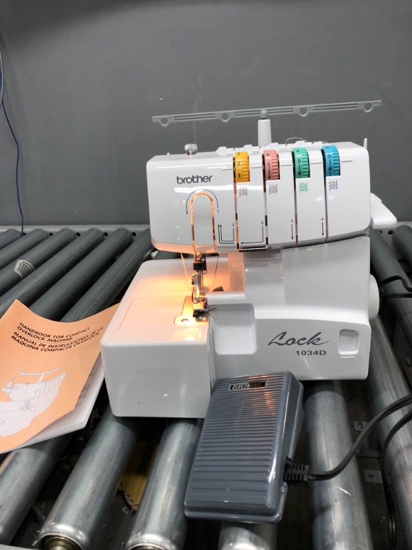 Photo 2 of Brother Serger, 1034D, Heavy-Duty Metal Frame Overlock Machine, 1,300 Stitches Per Minute, Removeable Trim Trap, 3 Included Accessory Feet,White
**Tested**