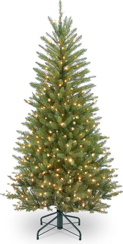 Photo 1 of National Tree Company Pre-Lit Artificial Slim Christmas Tree, Green, Dunhill Fir, White Lights, Includes Stand, 4.5 Feet
