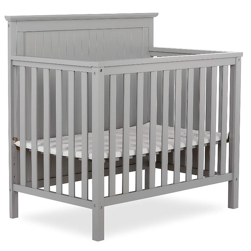 Photo 1 of Dream On Me Ava 4-in-1 Convertible Mini Crib in Pebble Grey, Greenguard Gold Certified, Non-Toxic Finish, Comes with 1" Mattress Pad, with 3 Mattress Height Settings
