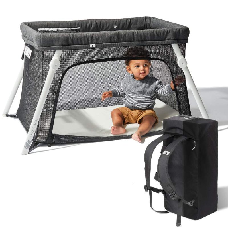 Photo 1 of *OPENED**
Lotus Travel Crib - Backpack Portable, Lightweight, Easy to Pack Play-Yard with Comfortable Mattress - Certified Baby Safe
