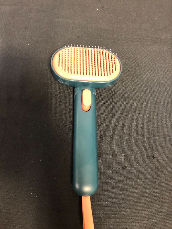 Photo 2 of Aumuca cat brush and dog brush (DUST ON ITEM)
