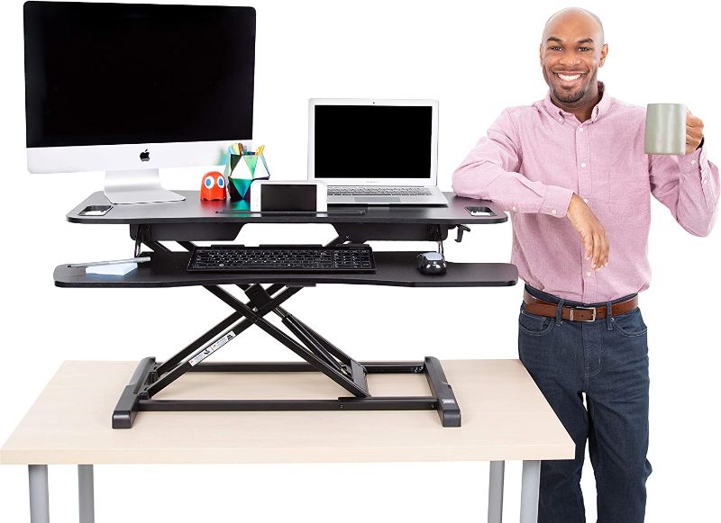 Photo 1 of Flexpro Hero 37 Inch Standing Desk | 2 Level Standing Desk Converter with Keyboard Shelf and Monitor Riser | Large Dual Level Sit to Stand Workspace | Easily Sit or Stand in Seconds! (Black / 37")
