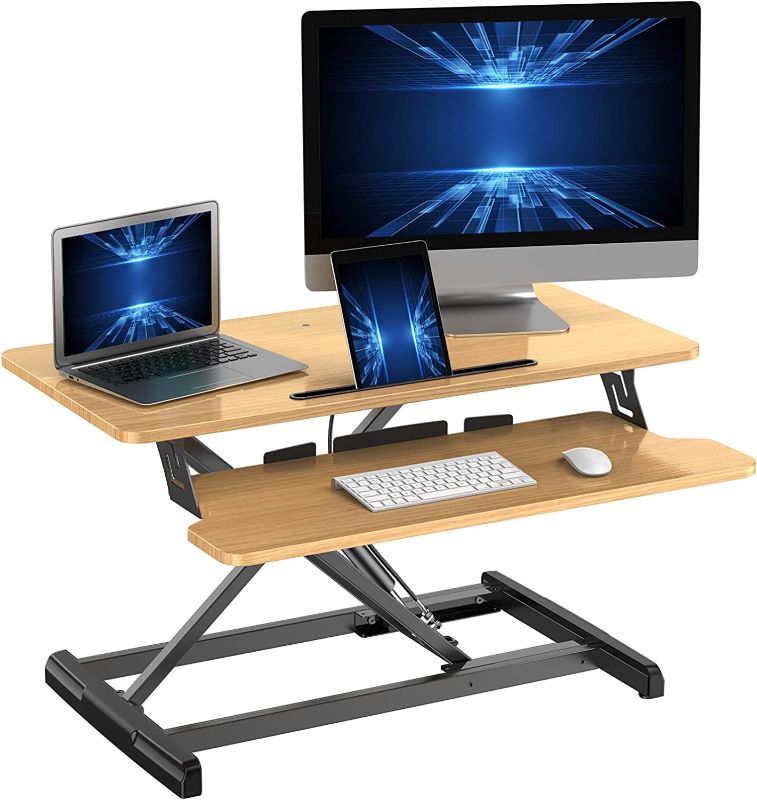 Photo 1 of ATUMTEK Standing Desk Converter, 32 Inch Height Adjustable Sit to Stand Desk Riser, Home Office Dual Monitor and Laptop Tabletop Workstation with Wide Keyboard Tray, Light Wood
