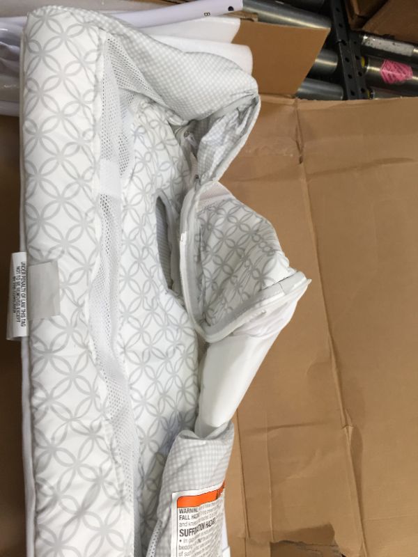 Photo 3 of Delta Children Newborn Soothing Sleeper Bassinet - Portable Baby Crib with Compact Fold, Grey Infinity. Box packaging Damaged, Minor Use, Found Hair on Item.