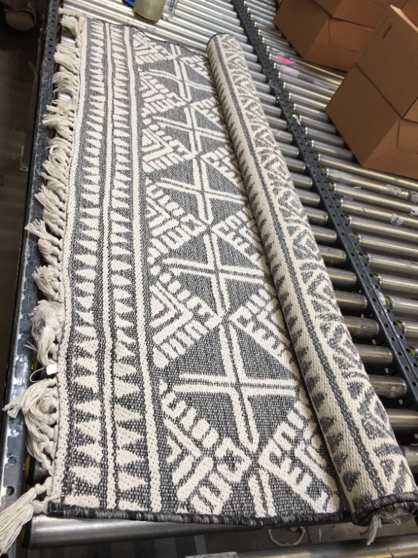 Photo 2 of 5' x 7' Tasseled Outdoor Rug Charcoal - Opalhouse™. Minor Use, Slightly Dirty From Shipping and Handling