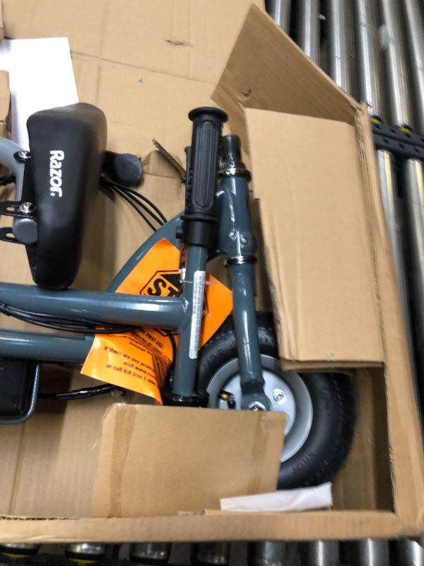 Photo 8 of Razor E300 Electric Scooter. Box Packaging Damaged, Minor Scratches and Scuffs on Metal, Turns on and Runs.  Missing Hardware For Seat