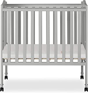 Photo 1 of Dream On Me 2-in-1 Lightweight Folding Portable Stationary Side Crib in Pebble Grey, Box Packaging Damaged, Moderate Use, Hardware Loose in Box, Missing Hardware. 
