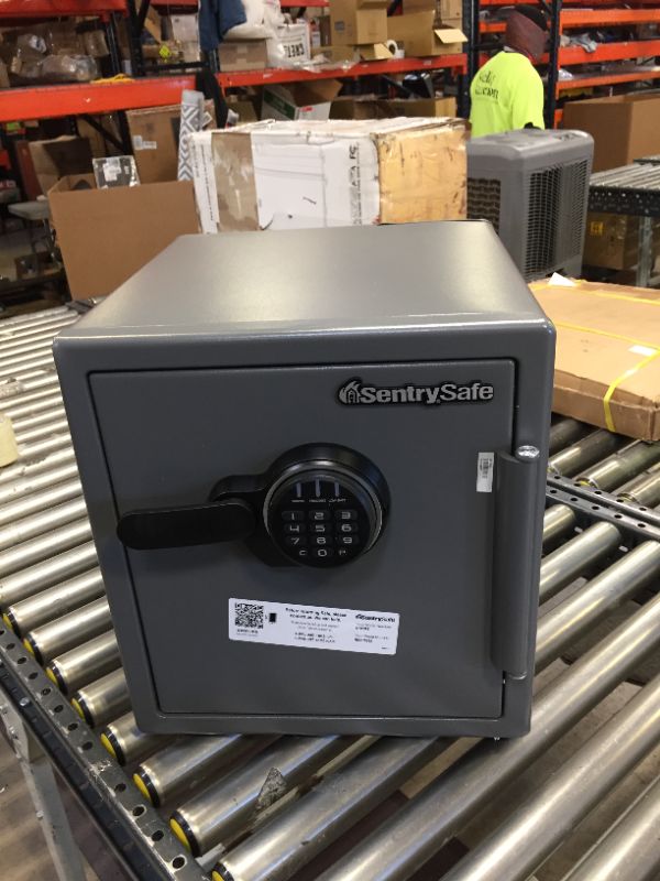 Photo 1 of SentrySafe SF123ES Fireproof Safe with Digital Keypad 1.23 Cubic Feet, Black. No Box Packaging, Moderate Use. Dents in Metal on Top Corner and Side, Locked Could not Open, Does not Light up, Batteries Could be Dead
