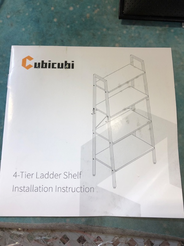 Photo 1 of 4 TIER LADDER SHELF 
OUT OF BOX ITEM 