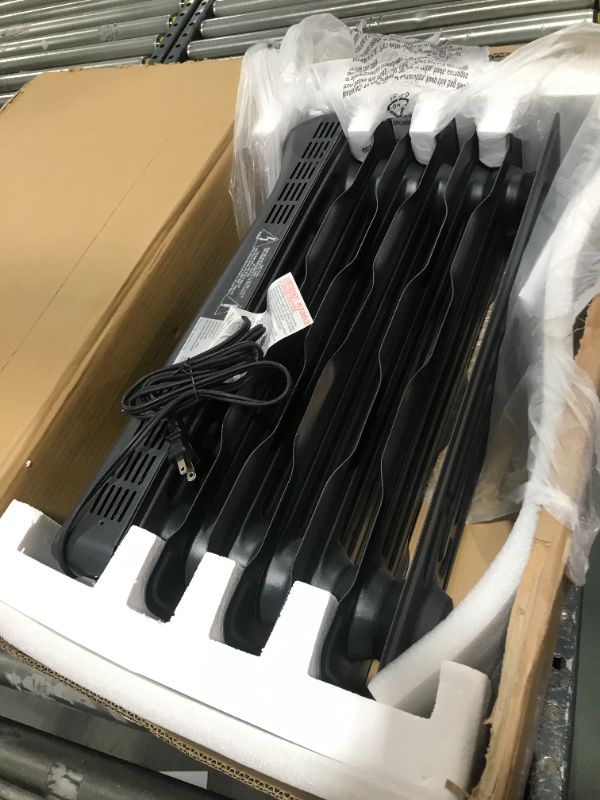 Photo 1 of Amazon Basics Portable Radiator Heater with 7 Wavy Fins, Manual Control, Black, 1500W
