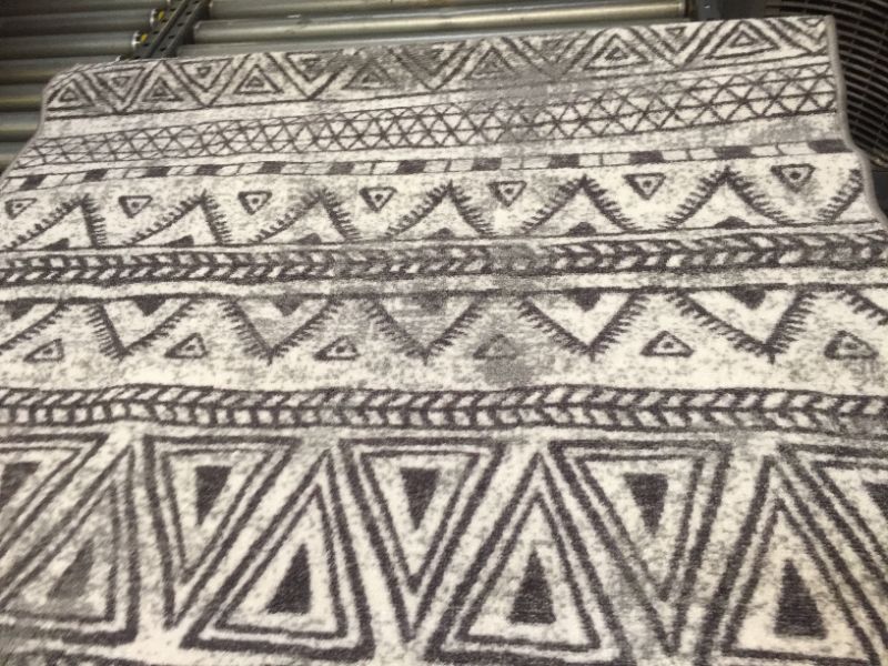 Photo 2 of 39"x58" Gray and Black Pattern Rug, No Box Packaging, Moderate Use, Creases and Wrinkles in item. Minor Fraying on Edges, Hair Found on item, Dirty From Shipping and Handling, Tape found on Item
