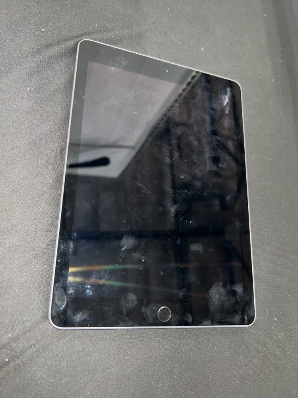 Photo 1 of IPAD 6TH GENERATION, MODEL #A1893 ( ITEM IS USED HAS SCRATCHES AND FINGERPRINTS THROUGHOUT. DOES NOT COME WITH BOX OR CHARGER)
